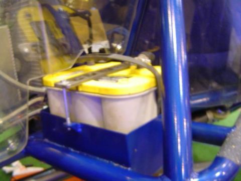 1979 Ford Bronco - Close-up of a yellow top Optima battery mounted in a blue bracket.