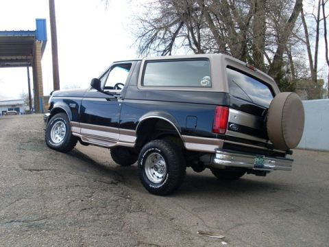 1996 Ford Bronco - This Ford Bronco is parked on an incline with a spare tire mounted on the rear.