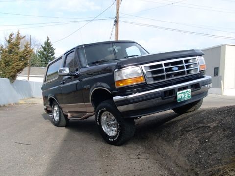 1996 Ford Bronco - This 1996 Ford Bronco is captured from a 3/4 front angle while parked on a dirt embankment.