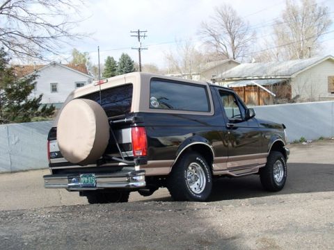 1996 Ford Bronco - Rear view of a 1996 Ford Bronco, showing the spare tire carrier and two-tone paint.