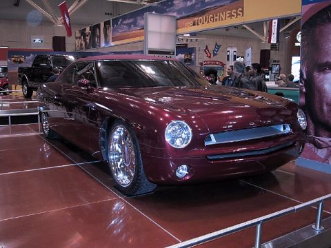 1996 Ford Taurus - This custom coupe, possibly a concept car, was displayed at an auto show alongside other vehicles.