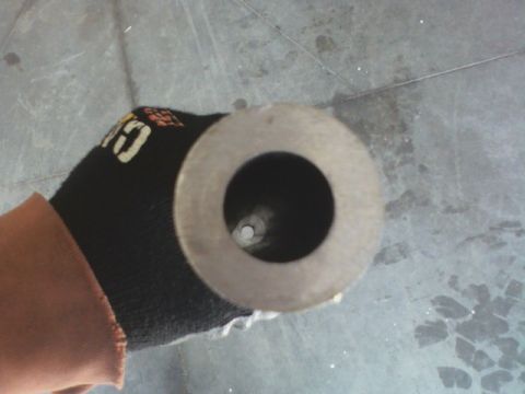 1992 Ford F-350 - A gloved hand holds a metal pipe, revealing a dark interior through its central opening. A website logo is visible in the corner.
