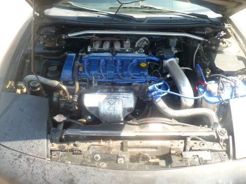 1993 Ford Probe - The engine bay of a car is shown with various components and wiring visible.