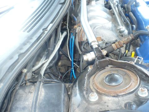 1993 Ford Probe - Close-up view of engine bay components, including blue hoses and various wires.
