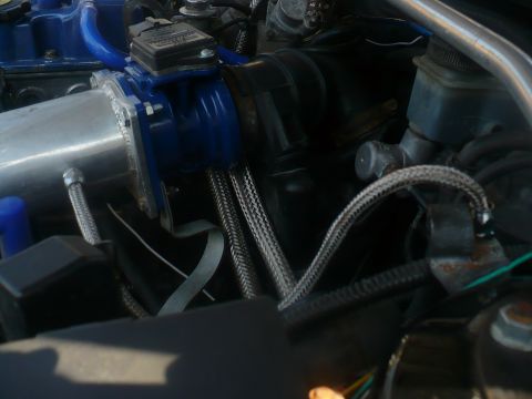 1993 Ford Probe - Close-up view of engine bay components including intake manifold and hoses.