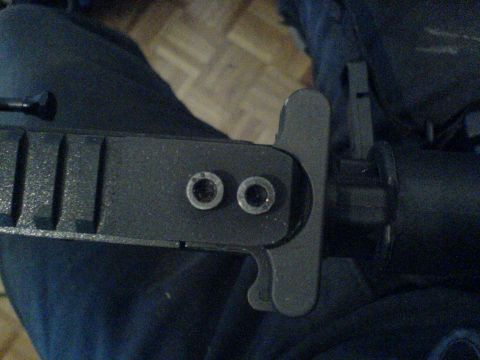 1985 Ford Bronco - A close-up view of a firearm component, showing two rivets and textured detailing.