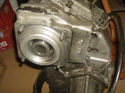 1986 Ford Bronco - Transfer case part with visible splined input shaft and stamped markings.
