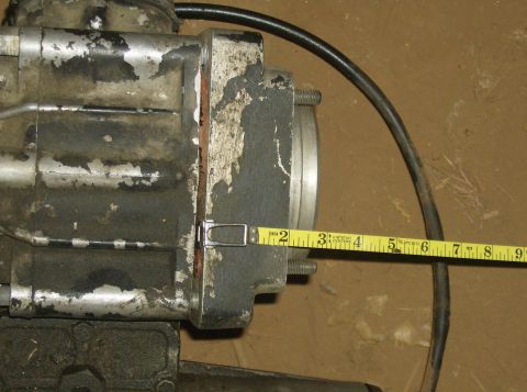 1986 Ford Bronco - Automotive part being measured with a tape measure. The part appears to be dirty and worn.