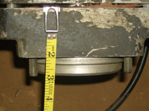 1986 Ford Bronco - A yellow tape measure is used to measure a section of a metal component, indicating a measurement of approximately 2 inches.