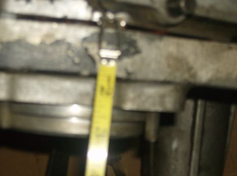 1986 Ford Bronco - A yellow measuring tape is shown against a metal engine component.