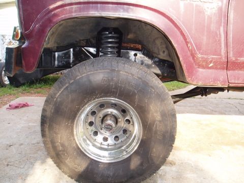 1980 Ford Bronco - Close-up of the front wheel and suspension system on a 1980 Ford Bronco.
