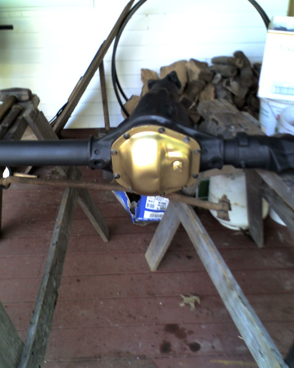 Rear axle differential with gold cover, supported by sawhorses