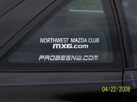1989 Mazda MX-6 - A window sticker reads "Northwest Mazda Club MX6.com" and "Probesnw.com" on the rear quarter window of a black vehicle.