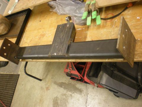 1993 Ford Bronco - A custom tire carrier mount is shown, likely for an off-road vehicle, resting on a workbench.