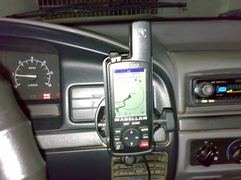 1995 Ford F-150 - Interior dash view of a gray truck cab with a Magellan 320 handheld GPS mounted on a vent bracket showing a track map on screen. The tachom…