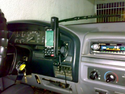 1995 Ford F-150 - Interior shot across a gray truck dash showing a handheld Magellan GPS 320 unit mounted on the dash bezel with its green map screen on and…