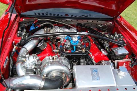 1992 Ford Crown Victoria - Customized engine bay features a prominent turbocharger and a Cobra emblem on a coolant reservoir.