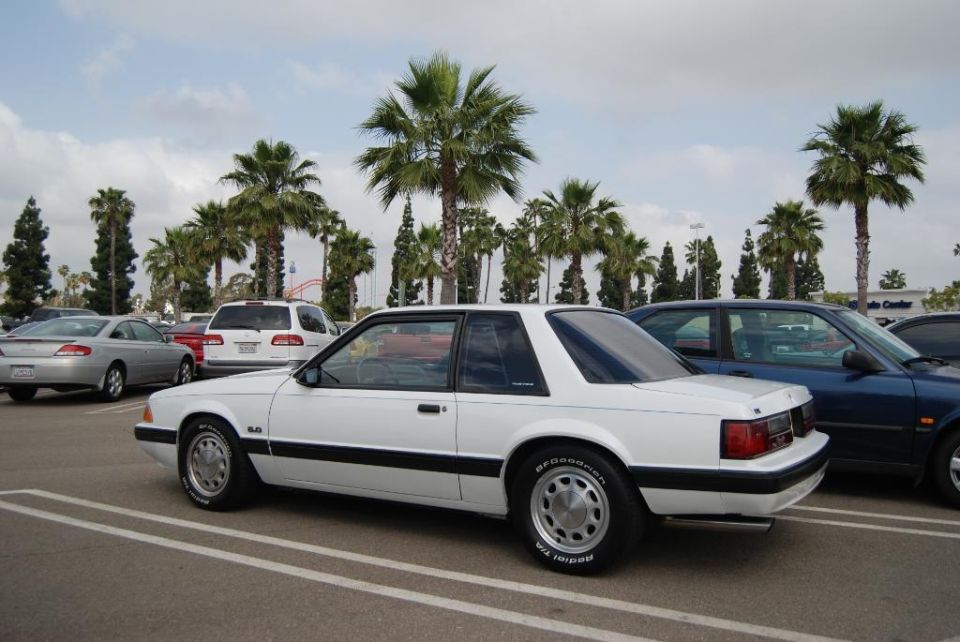White coupe with black trim and BFGoodrich tires parked in a lot