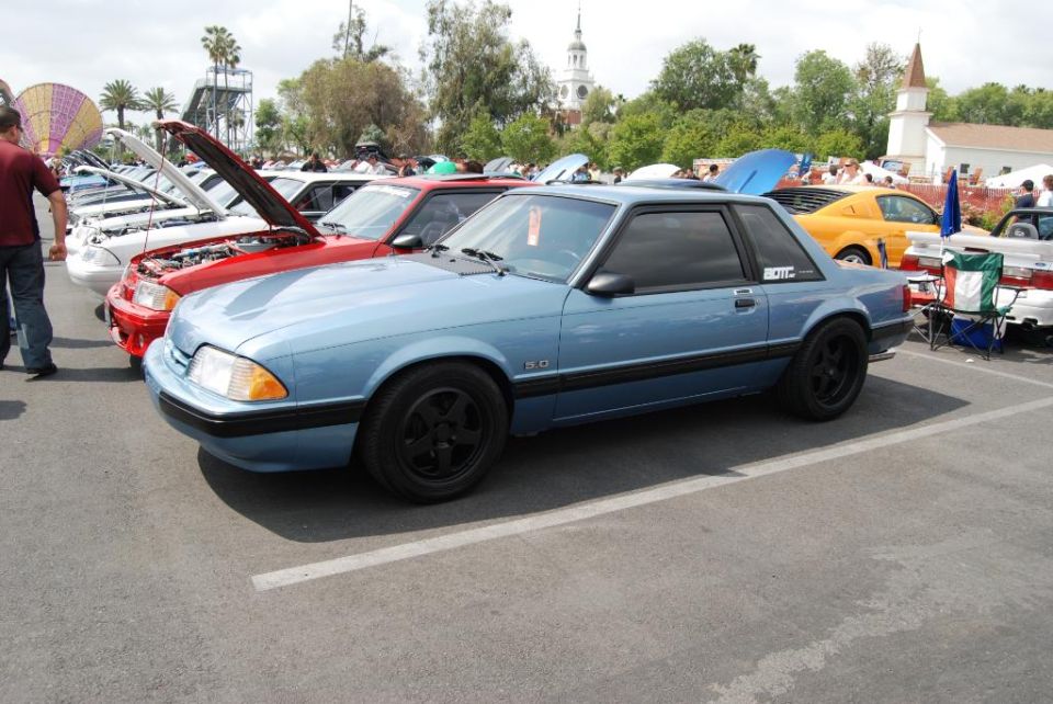 Blue coupe with black wheels and a '5.0' badge