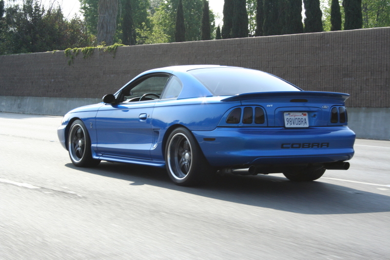 Blue 1996 Ford Mustang Cobra with a rear spoiler and Cobra badging
