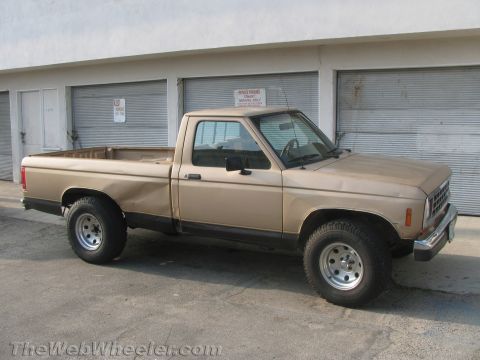 1968 Ford Mustang - This is a tan Ford Ranger pickup truck with a dented rear fender.