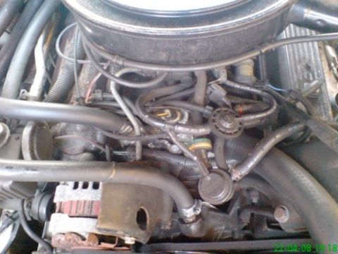 1987 Pontiac Firebird - The engine compartment of a vehicle, showing various mechanical components and wiring.