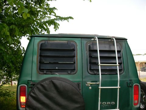 1978 Ford E250 - Rear view of a green 1978 Ford E250 van, equipped with louvred windows and a rear ladder.