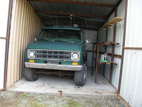1978 Ford E250 - Front view of a green 1978 Ford E250 van parked inside a metal shed.