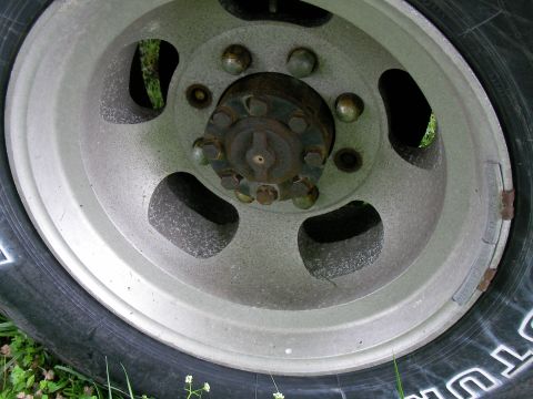 1978 Ford E250 - A close-up view of a truck's wheel hub, showing the lug nuts and part of the silver rim.