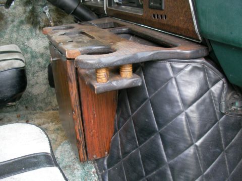 1978 Ford E250 - Custom wooden console with cup holders and quilted floor mat visible in the interior of a van.