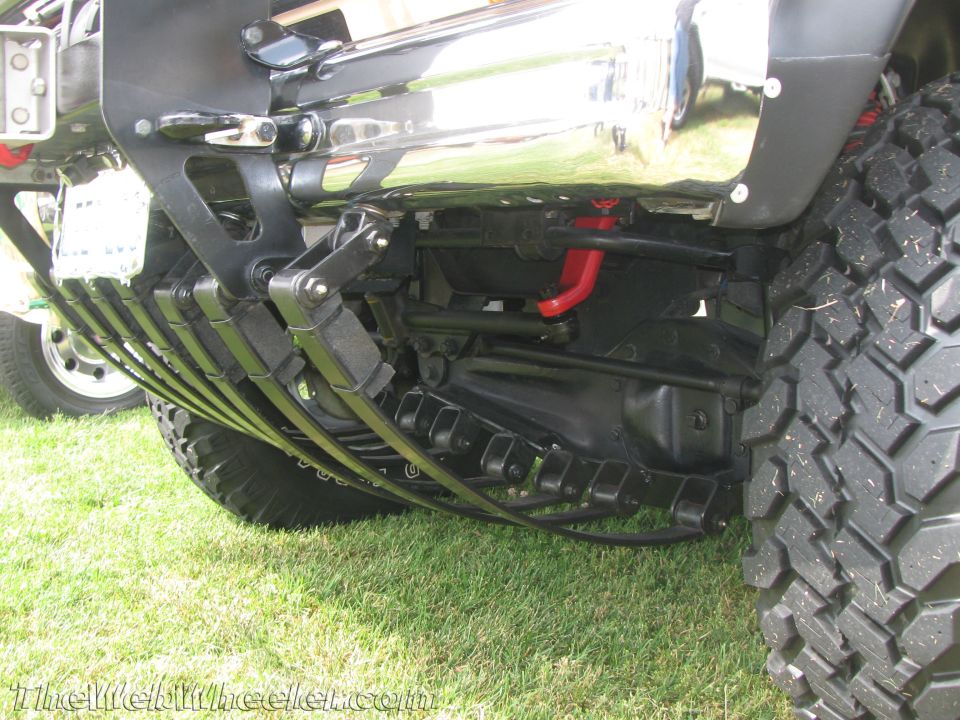 Truck rear suspension with leaf springs, differential, and tow hook