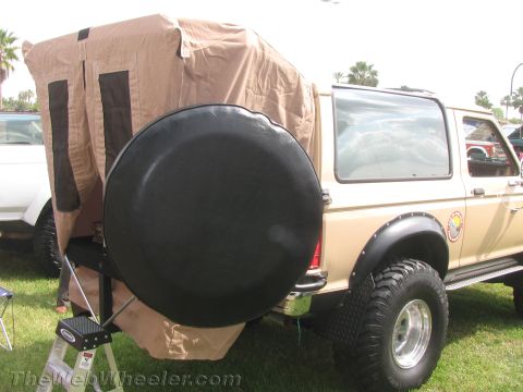 1968 Ford Mustang - This Ford Bronco is equipped with a camper shell and spare tire, with another vehicle nearby.