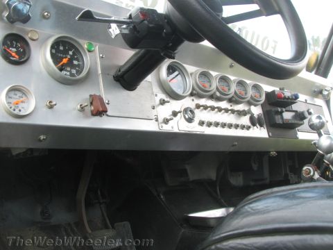 1968 Ford Mustang - Interior view of a custom dashboard filled with gauges and switches.
