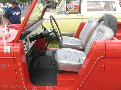 1968 Ford Mustang - Interior view of a red Ford Bronco, with another Bronco visible in the background.