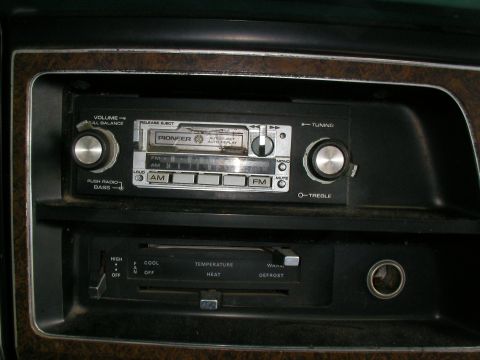 1978 Ford E250 - Close-up of a car's dashboard showing a vintage Pioneer radio and climate control panel.