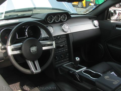 1968 Ford Mustang - Interior view of a Ford Mustang, likely from the 2005-2014 generation, a Cobra emblem.