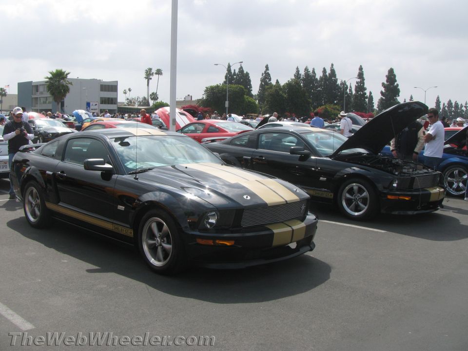Black 2008 Ford Mustang GT500 with gold stripes, front 3/4 view