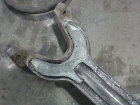 1992 Ford F-350 - This is a close-up view of a worn suspension part, likely from a vehicle.
