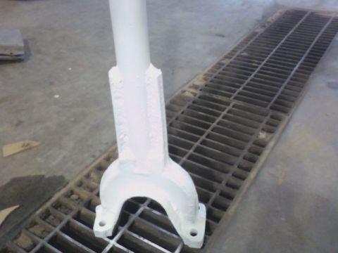 1992 Ford F-350 - A close-up view of a white painted metal component resting on a floor grate.