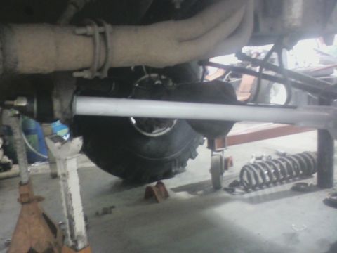 1992 Ford F-350 - The underside of a 1992 Ford F-350 is visible, with suspension parts and a large tire in view.