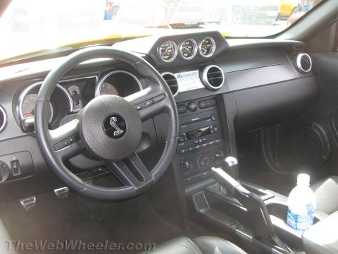 1968 Ford Mustang - Interior view of a Ford Mustang, a Shelby Cobra emblem on the steering wheel.