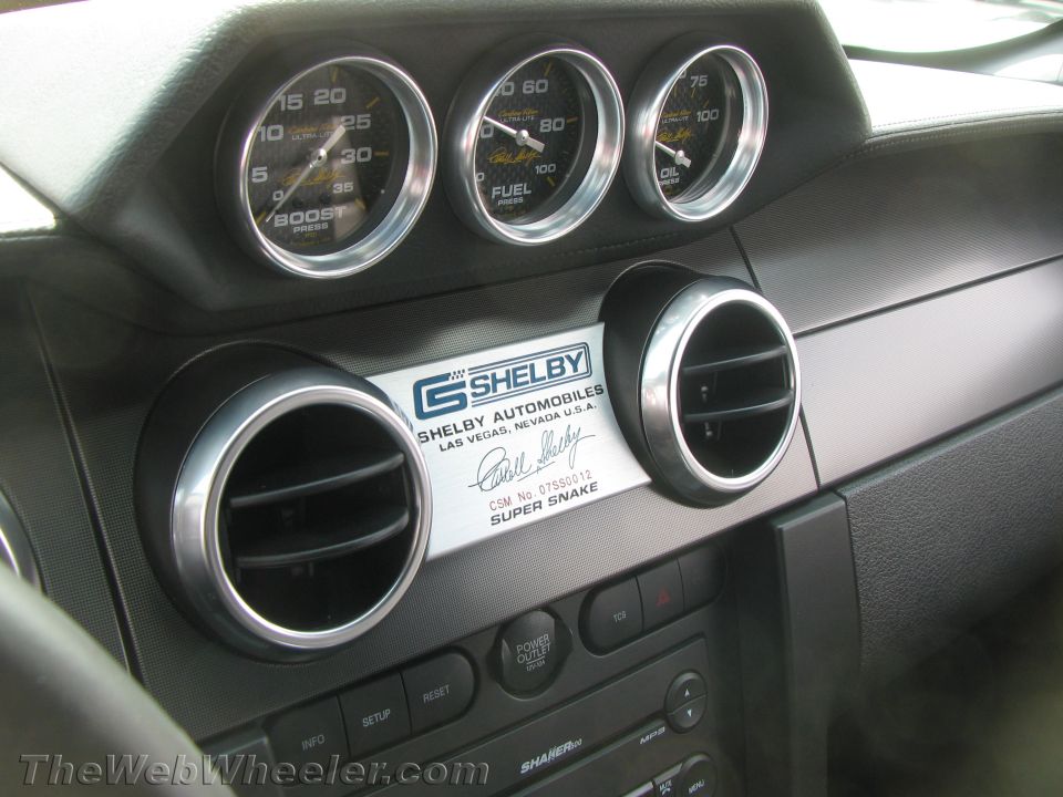 Car interior with three gauges (boost, fuel, oil) and Shelby Super Snake badging