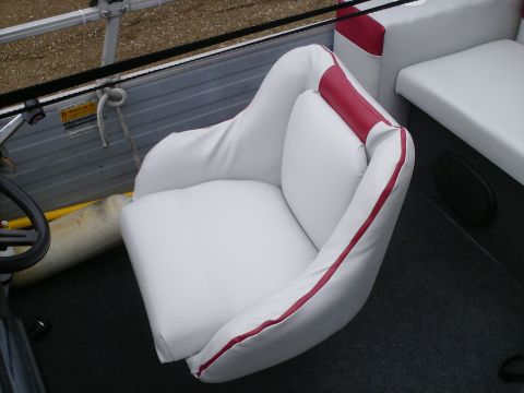 White boat seat with red trim and steering wheel visible