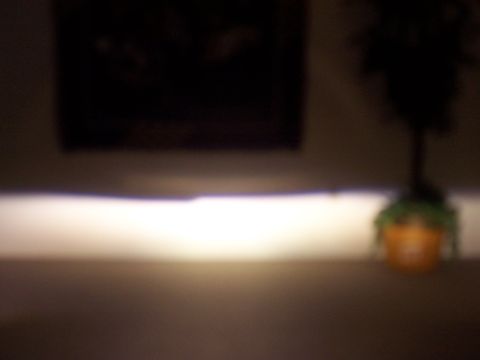 1993 Ford Probe - The front of a 1993 Ford Probe GT is visible in this dimly lit photograph.