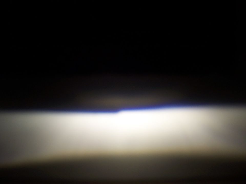 Headlight beam with blue tint at top