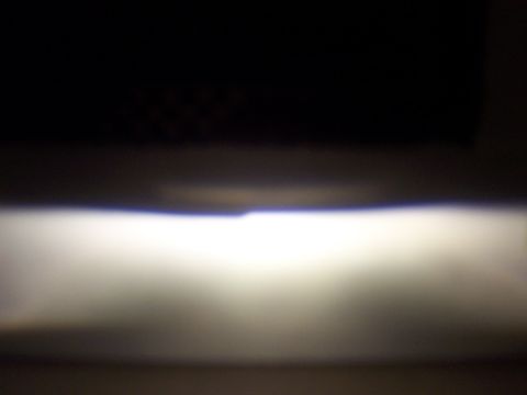 1993 Ford Probe - A bright headlight beam is visible against a dark background, with a website watermark at the bottom.