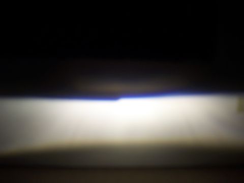 1993 Ford Probe - The bright beam of a car's headlight cuts through the darkness, with a website logo in the corner.