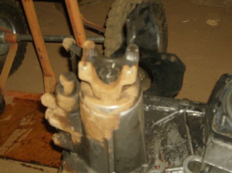 1986 Ford Bronco - This image shows a close-up view of a vehicle's drivetrain components, specifically a u-joint and part of a driveshaft.