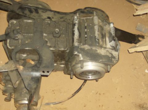 1986 Ford Bronco - A close-up view of a vehicle transfer case, showing its internal components and external casing.