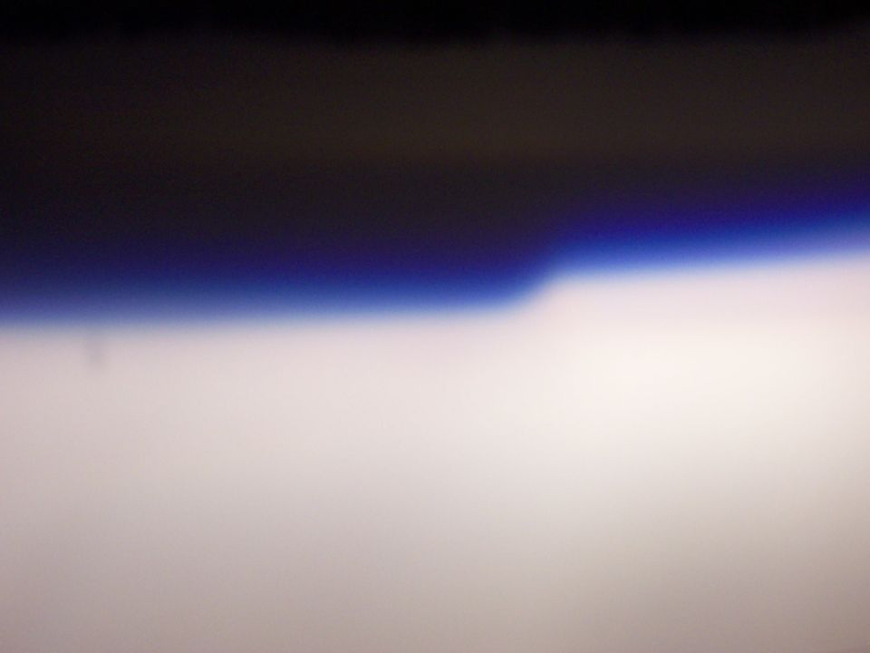 Horizon line with dark sky above and bright sky below, SUPERMOTORS.NET logo at bottom right